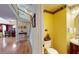 Quaint powder room with yellow walls, decorative wallpaper, and modern fixtures at 103 Haleswood Cir, Goose Creek, SC 29445
