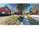 Street view of a well-maintained brick home with blue shutters and mature landscaping at 103 Haleswood Cir, Goose Creek, SC 29445