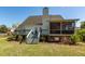 Exterior view of the home showcasing the deck, patio and landscaped yard at 104 Abrum Ct, Goose Creek, SC 29445