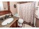 Bathroom featuring a granite countertop, decorative mirror and stylish shower curtain at 104 Abrum Ct, Goose Creek, SC 29445