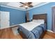 Bedroom featuring blue walls, a ceiling fan, crown molding, and wood floors at 104 Abrum Ct, Goose Creek, SC 29445