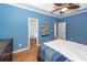 Bedroom with blue walls, wood floors, and an open door leading to the bathroom at 104 Abrum Ct, Goose Creek, SC 29445