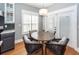 Charming breakfast nook features a round wood table with four wicker chairs, and white-trim french doors at 104 Abrum Ct, Goose Creek, SC 29445