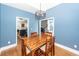 Dining room with a wooden table, four chairs, and blue walls at 104 Abrum Ct, Goose Creek, SC 29445
