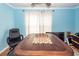 Dining room with a chess set on a wooden table, bright blue walls and natural light at 104 Abrum Ct, Goose Creek, SC 29445