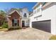 A two-story brick and white siding home with a two-car garage and well-manicured landscaping at 104 Abrum Ct, Goose Creek, SC 29445