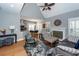 Inviting living area flows to kitchen, featuring fireplace, neutral tones, and hardwood flooring at 104 Abrum Ct, Goose Creek, SC 29445