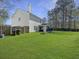 Spacious fenced backyard with lush green lawn and fire pit, perfect for outdoor entertaining at 104 Salem Rd, Ladson, SC 29456
