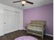 Bedroom with hardwood floors and a purple accent wall at 104 Salem Rd, Ladson, SC 29456