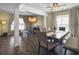 Inviting dining room featuring a dark wood table, modern ceiling fan, and neutral-toned curtains for a cozy atmosphere at 104 Salem Rd, Ladson, SC 29456