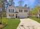 Charming two-story home with a covered front porch, well-maintained lawn, and attached two-car garage at 104 Salem Rd, Ladson, SC 29456