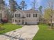 Charming two-story home with a front porch, well-manicured lawn, and a long driveway at 104 Salem Rd, Ladson, SC 29456
