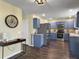 Well-lit kitchen featuring blue cabinets, stainless steel appliances, and wood-look flooring at 104 Salem Rd, Ladson, SC 29456