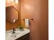 Stylish powder room with a modern vanity, hexagon mirror, and warm-toned walls at 104 Salem Rd, Ladson, SC 29456