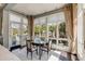 Bright breakfast nook with floor-to-ceiling windows and an elegant round table seating four at 106 Murray Blvd, Charleston, SC 29401