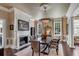 Formal dining room with fireplace, large windows, and stylish chandelier at 106 Murray Blvd, Charleston, SC 29401