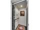 An interior shot of an elevator showing the gate and controls, with a carpeted floor and painting at 106 Murray Blvd, Charleston, SC 29401