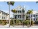 Beautiful three-story home with balconies, palm trees, and manicured landscaping at 106 Murray Blvd, Charleston, SC 29401