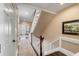 Elegant hallway with stairs and carpet runner, leading to a bright living space at 106 Murray Blvd, Charleston, SC 29401