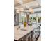Detail of kitchen island with marble countertop, seating, and views to the dining area at 106 Murray Blvd, Charleston, SC 29401