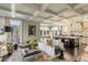 Spacious open-concept living room and kitchen area with coffered ceiling and hardwood flooring at 106 Murray Blvd, Charleston, SC 29401