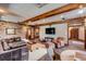 Spacious living room with brick walls, wood beams, and a comfortable leather sofa at 106 Murray Blvd, Charleston, SC 29401