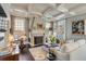 Inviting living room with coffered ceilings, a stone fireplace, and neutral-toned furnishings at 106 Murray Blvd, Charleston, SC 29401