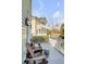 Relaxing porch area featuring outdoor seating, with a view of the surrounding neighborhood and blue sky at 106 Murray Blvd, Charleston, SC 29401