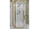 Modern shower with glass door, gold trim, and white tiled walls at 106 Murray Blvd, Charleston, SC 29401