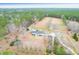 High aerial shot shows a charming home with in-ground pool, garage, and well-maintained landscaping at 1158 Wildgame Rd, Summerville, SC 29486