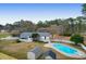 Aerial view showcasing the home, a large pool, and mature trees at 1158 Wildgame Rd, Summerville, SC 29486