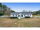 Charming white brick home featuring a metal roof and well-manicured landscaping at 1158 Wildgame Rd, Summerville, SC 29486