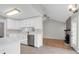 Well-appointed kitchen with stainless appliances, white cabinetry, and a view of the living area at 1158 Wildgame Rd, Summerville, SC 29486