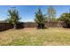 Backyard featuring a green lawn, a wooden fence, and a view of overhead sports lights at 1166 Elliotts Cut Dr, Charleston, SC 29412