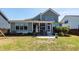Well-maintained backyard with patio, grill, lush lawn and view of the house at 1166 Elliotts Cut Dr, Charleston, SC 29412
