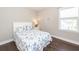 Bedroom with hardwood floors, a white bed frame, neutral paint, and a decorative mirror on the wall at 1166 Elliotts Cut Dr, Charleston, SC 29412