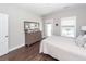 Bedroom with hardwood floors, large window, light gray walls, and a wooden dresser and mirror at 1166 Elliotts Cut Dr, Charleston, SC 29412