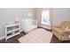 Bedroom features a white crib, pink accents, dark wood floors, and a cozy chair at 1166 Elliotts Cut Dr, Charleston, SC 29412