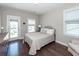 Bright bedroom with a balcony door, hardwood floors, neutral paint, and a gray upholstered headboard bed frame at 1166 Elliotts Cut Dr, Charleston, SC 29412