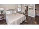 Bedroom features an upholstered chair, hardwood floors, a gray headboard bed frame, and an ensuite bathroom at 1166 Elliotts Cut Dr, Charleston, SC 29412