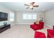 Spacious bonus room with large windows, neutral carpeting, and comfortable red armchairs at 1166 Elliotts Cut Dr, Charleston, SC 29412