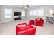 Cozy bonus room with plush carpeting, a ceiling fan, and comfortable red armchairs and ottomans at 1166 Elliotts Cut Dr, Charleston, SC 29412