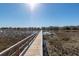 A beautiful community dock stretches out over the marsh, with homes in the distance at 1166 Elliotts Cut Dr, Charleston, SC 29412