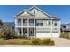 Charming two-story home with a double front porch and manicured landscaping at 1166 Elliotts Cut Dr, Charleston, SC 29412