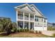 Charming two-story home with a welcoming porch, a second story balcony, and well-manicured landscaping at 1166 Elliotts Cut Dr, Charleston, SC 29412