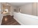 Bright hallway with hardwood floors and white wainscoting leading to a room with a mirror and a small side table at 1166 Elliotts Cut Dr, Charleston, SC 29412