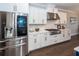 Bright, modern kitchen with stainless steel appliances, white cabinets and island cooktop at 1166 Elliotts Cut Dr, Charleston, SC 29412