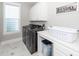 Well-lit laundry room with modern washer and dryer units, ample counter space, and stylish decor at 1166 Elliotts Cut Dr, Charleston, SC 29412