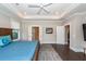 Bright main bedroom with a wooden bed frame, bedside table, and access to additional rooms at 1166 Elliotts Cut Dr, Charleston, SC 29412