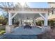 A charming outdoor pavilion with brick supports, a picnic table and ceiling fan for relaxation at 1166 Elliotts Cut Dr, Charleston, SC 29412